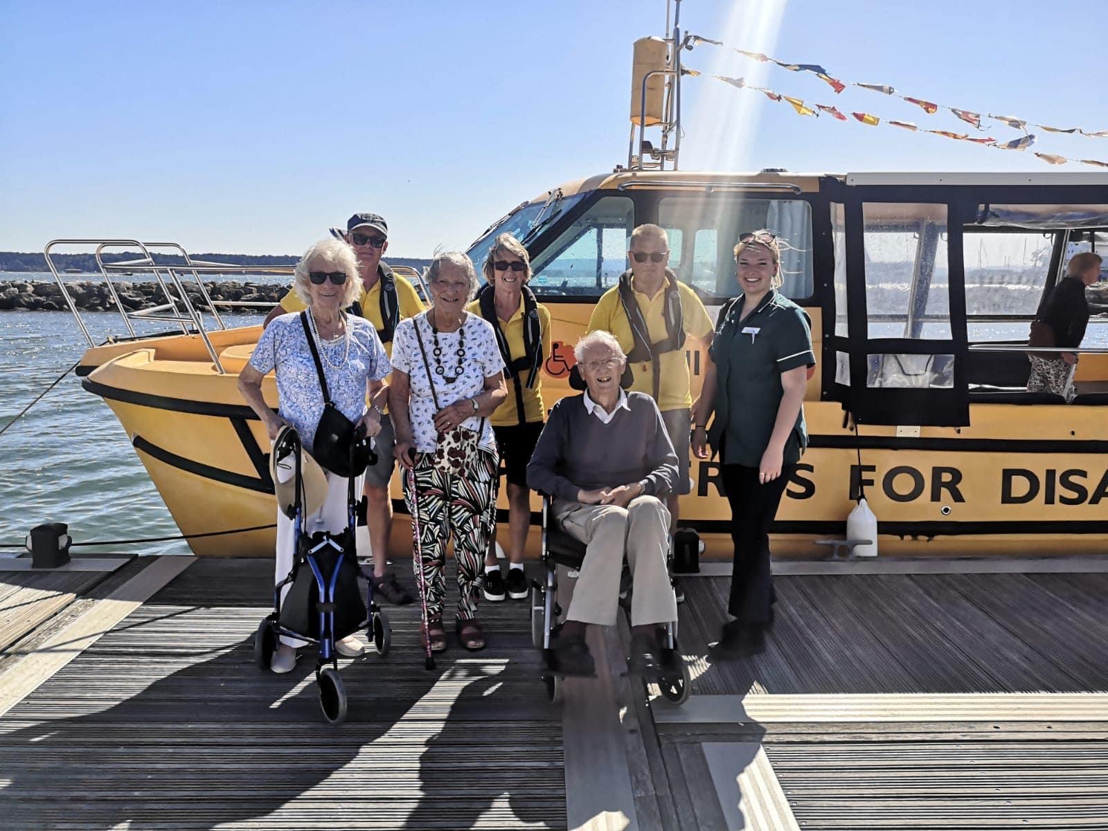The couple with Upton Bay staff and boat crew ahead of their trip