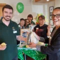 Sam Reid, Home Manager of The Aldbury, presents the Golden Cup Cake prize to winner and Housekeeping colleague Michael Sheppard. With them are, from second left: colleagues Merle Foster, Kanya Brannon, Janette Burgess and Nimpha Salmon