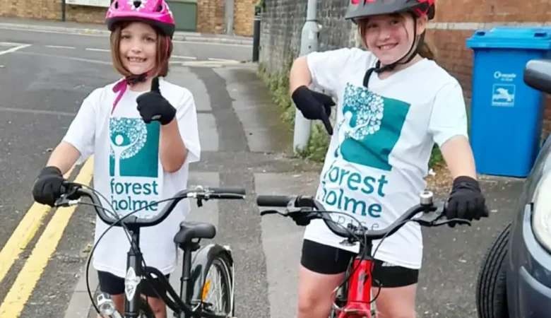 Macy and Pippa get on their bikes for Forest Holme Hospice Charity