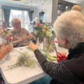 Residents enjoying flower arranging at Moors Manor care home