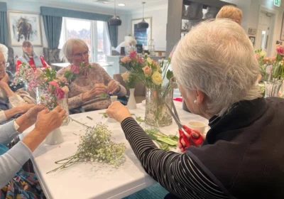 Residents enjoying flower arranging at Moors Manor care home
