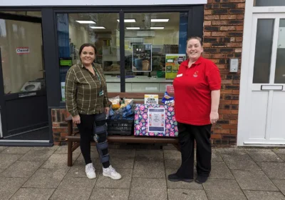 Lauren Parrett, right, Companionship Team Leader at Colten Care’s Brook View care home, hands over donated food items to Michelle Bennett who manages the nearby community larder in West Moors