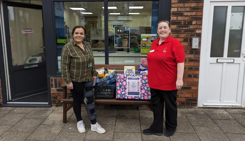 Lauren Parrett, right, Companionship Team Leader at Colten Care’s Brook View care home, hands over donated food items to Michelle Bennett who manages the nearby community larder in West Moors