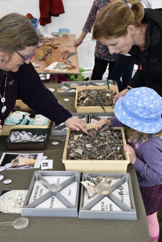 Visitors inspecting finds at a previous Festival of Archeology event Picture National Trust, Clive Whitbourn