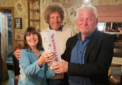 Viv and Dave Arkell receiving their Champagne prize from Wimborne mayor, Cllr Jeff Hart