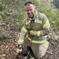 Lando pictured smiling with an on-call firefighter who rescued him Picture: Hampshire & Isle of Wight Fire and Rescue Service