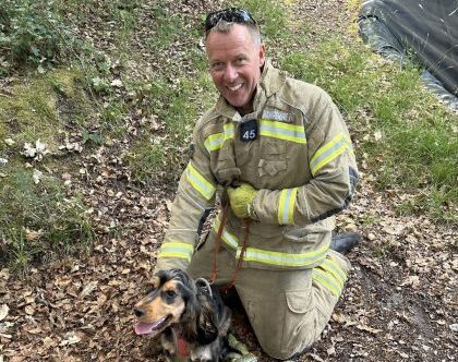 Lando pictured smiling with an on-call firefighter who rescued him Picture: Hampshire & Isle of Wight Fire and Rescue Service