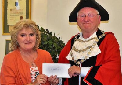 Heather Lowe from Planet Wimborne receiving the donation from cllr Jeff Hart Picture: Tom Scrase