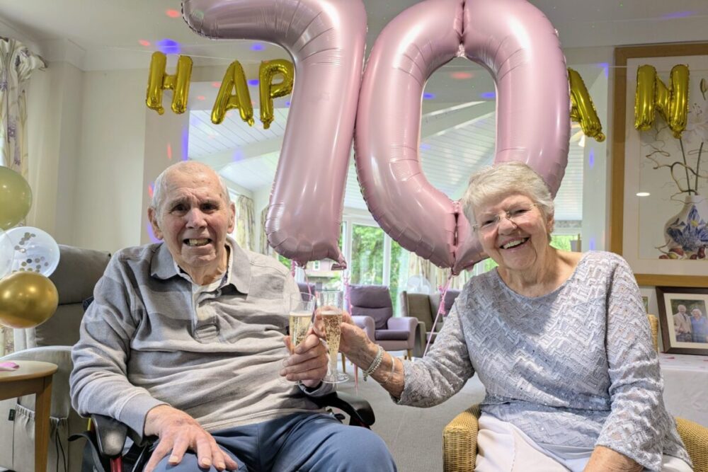 The couple celebrating their anniversary with a glass of fizz Picture: Care South