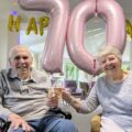 The couple celebrating their anniversary with a glass of fizz Picture: Care South