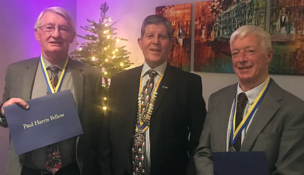 Paul Harris Awards were presented to David Sumner, left, and Chris Mogg, right, by Wimborne Rotary President Brian Dryden, centre