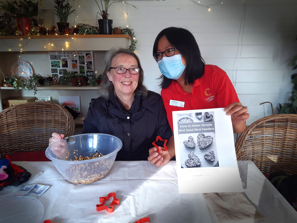 Valerie Short and Companion Melissa Siat making bird seed ornaments