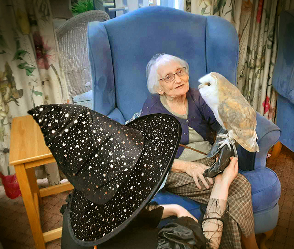 Brook View resident Iona Midlane with an owl brought along on Halloween by Creature Teachers.